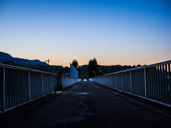 Road against clear sky at sunset