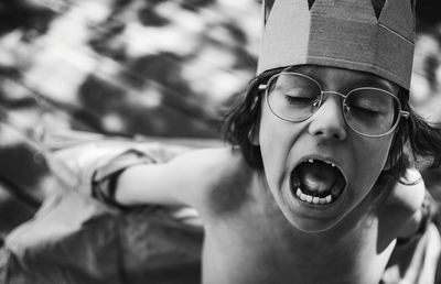 Portrait of screaming boy with crown on his head