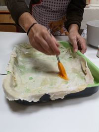 Midsection of man preparing food in plate