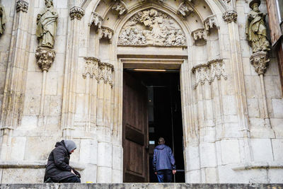 Woman begging outside church