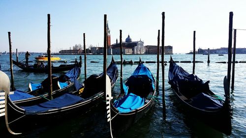 Boats moored in river