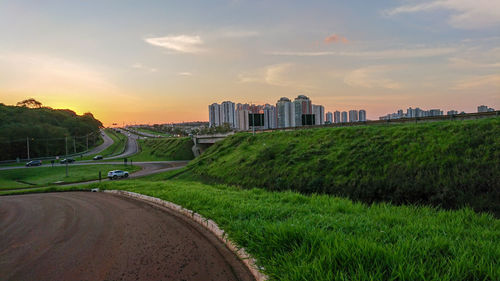 Panoramic view of city buildings against sky during sunset