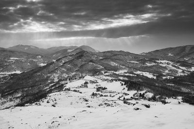 Scenic view of snow covered mountains against sky