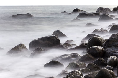 Scenic view of sea with rocky shore