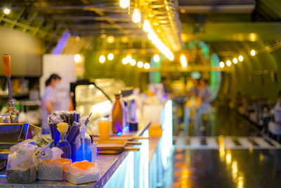 Close-up of illuminated candles on table at restaurant