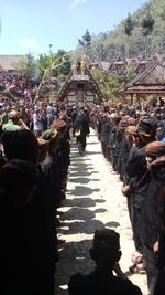 Group of people walking against built structure