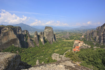 Scenic view of rocky mountains against blue sky