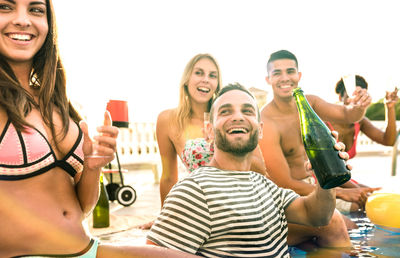 Cheerful of friends enjoying at swimming pool