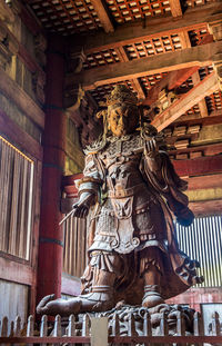 Low angle view of statue against building