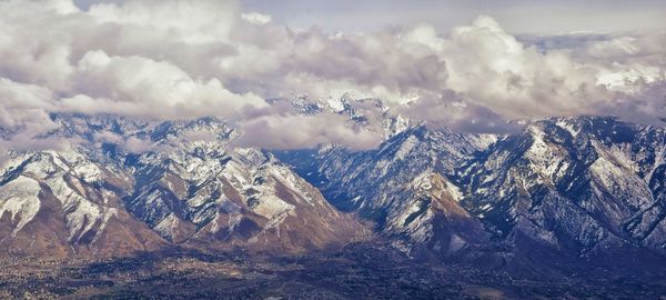 Wasatch front rocky mountain range aerial snow capped peaks winter urban salt lake city utah usa