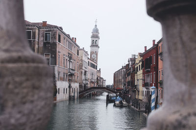 Bridge over canal amidst buildings in city