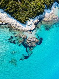 High angle view of rocks on sea shore