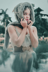 Portrait of woman standing in water