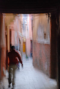 Rear view of woman walking on street in city