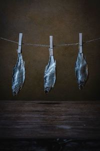 Close-up of ice cream hanging on table against wall