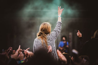 Rear view of people enjoying at music concert