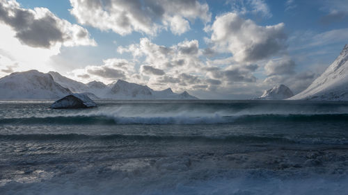 Scenic view of sea and mountains against sky