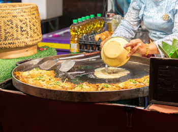 Midsection of man preparing food on table