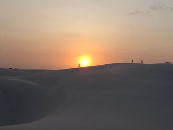 Scenic view of desert against sky during sunset