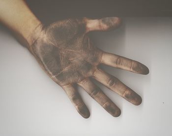 High angle view of person messy hand over gray background