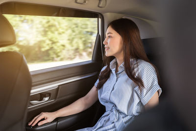 Young woman sitting in car