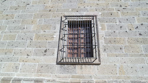 Low angle view of window on wall