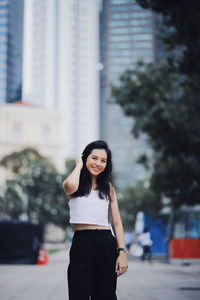 Portrait of woman standing in city