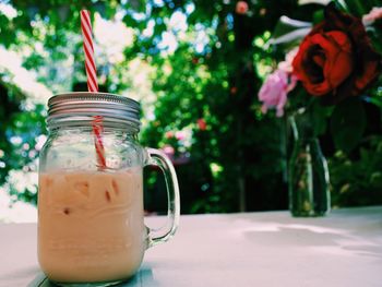 Close-up of iced coffee in mason jar on table