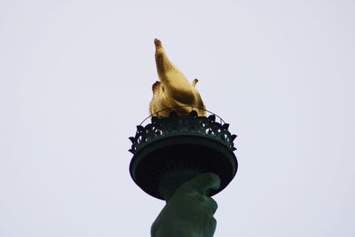 Low angle view of statue against white background