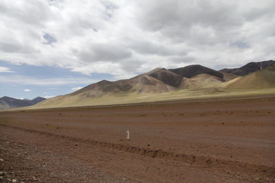 Beautiful mountains and red plateau meadows under the blue sky and white clouds