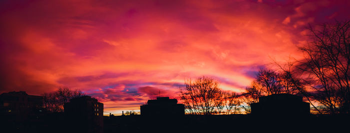 Silhouette cityscape against sky during sunset