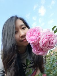 Close-up of woman with pink roses