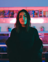 Portrait of young woman standing indoors