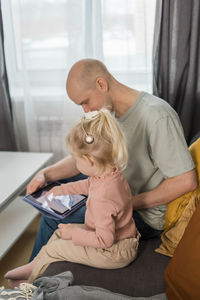 Side view of woman using digital tablet