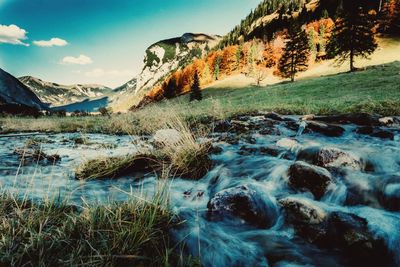 Scenic view of waterfall against sky