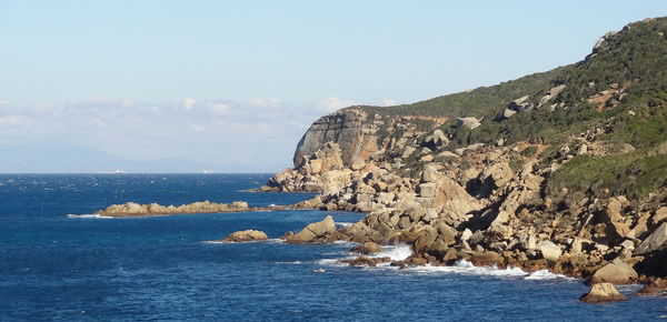 Scenic view of sea and rocks against sky