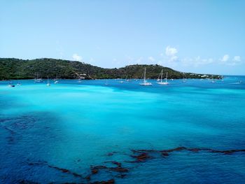 View of boats in calm blue sea