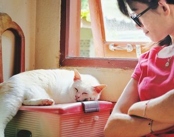 Young woman with cat at home