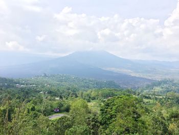 Scenic view of green landscape against sky