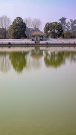 Scenic view of lake by building against sky