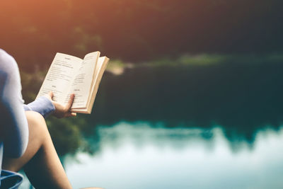 Midsection of person holding book