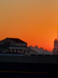 Residential buildings against sky during sunset