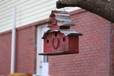 Birdhouse hanging against wall