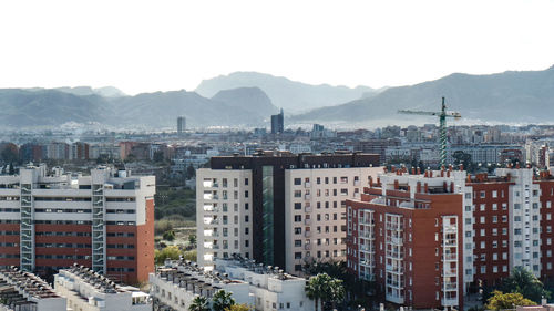 High angle view of buildings in city against sky