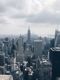 Aerial view of modern buildings in city against sky