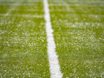 Detailed lines on soccer football field. sun makes reflection in plastic material