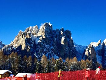 Scenic view of snowcapped mountains against clear blue sky