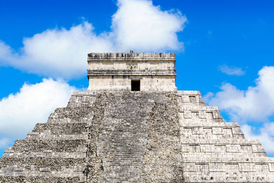 Low angle view of historical building against cloudy sky