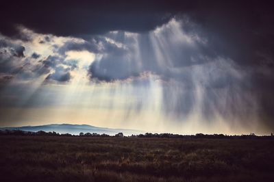 Scenic view of landscape against cloudy sky