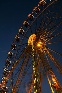 Ferris wheel lights at night. neon colored lights flashing on the ferris wheel. amusement park 